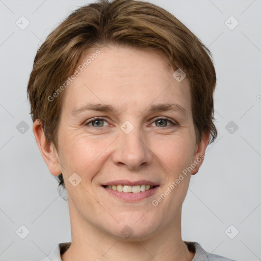 Joyful white adult female with short  brown hair and grey eyes