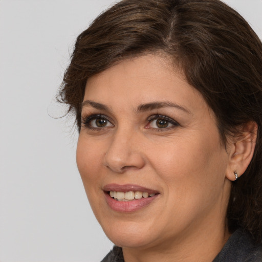 Joyful white adult female with medium  brown hair and brown eyes