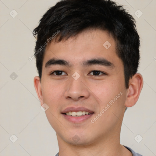 Joyful asian young-adult male with short  brown hair and brown eyes