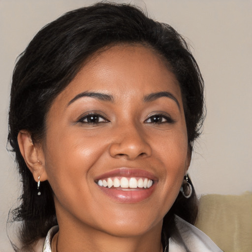 Joyful latino young-adult female with medium  brown hair and brown eyes