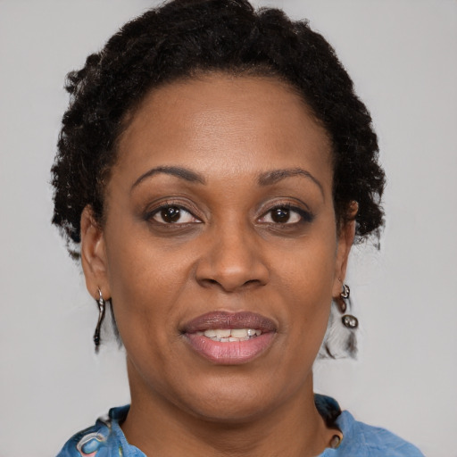 Joyful black adult female with short  brown hair and brown eyes