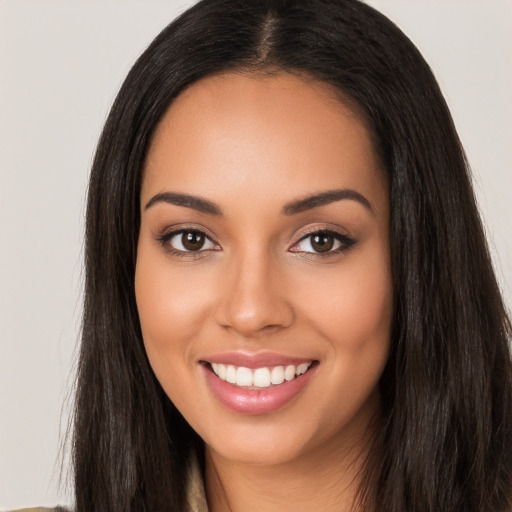 Joyful latino young-adult female with long  black hair and brown eyes