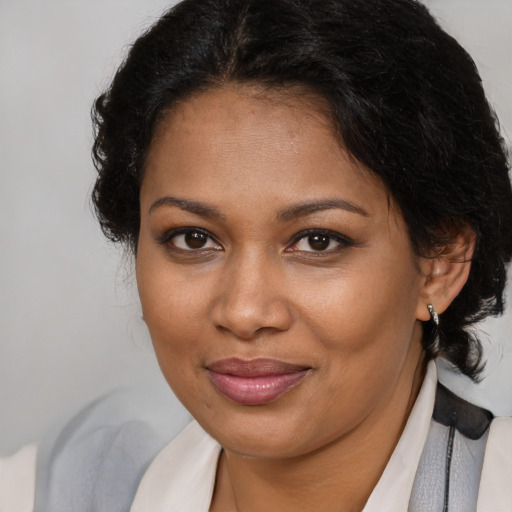 Joyful black young-adult female with medium  brown hair and brown eyes