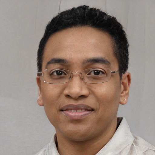 Joyful latino young-adult male with short  black hair and brown eyes