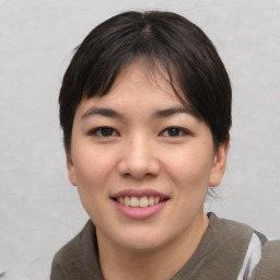 Joyful asian young-adult female with short  brown hair and brown eyes