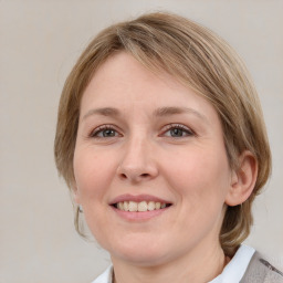 Joyful white young-adult female with medium  brown hair and blue eyes