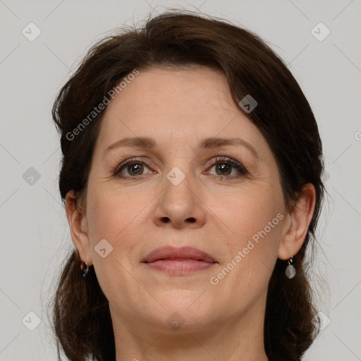 Joyful white adult female with medium  brown hair and grey eyes