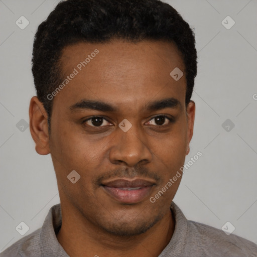 Joyful black young-adult male with short  brown hair and brown eyes