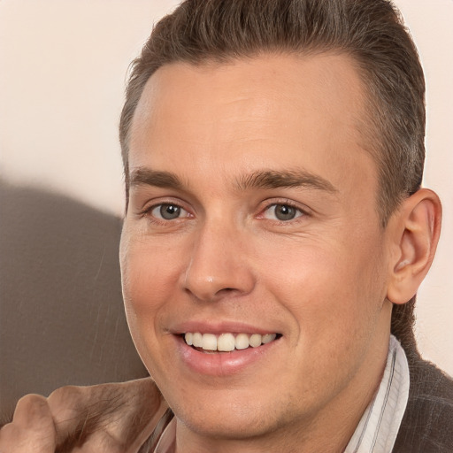 Joyful white adult male with short  brown hair and brown eyes