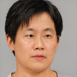 Neutral asian adult male with short  brown hair and brown eyes