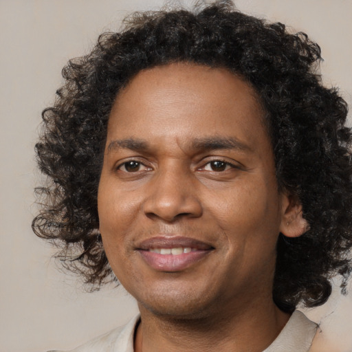 Joyful black young-adult male with medium  brown hair and brown eyes