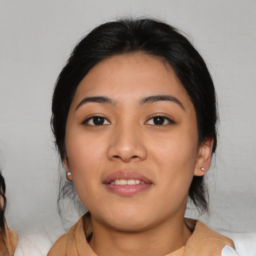 Joyful asian young-adult female with medium  black hair and brown eyes