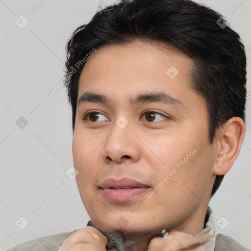 Joyful white young-adult male with short  black hair and brown eyes