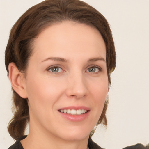 Joyful white young-adult female with medium  brown hair and grey eyes