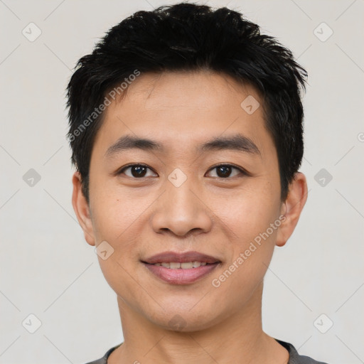 Joyful asian young-adult male with short  black hair and brown eyes