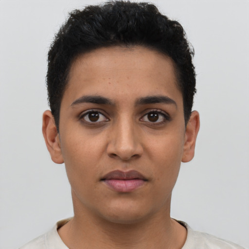 Joyful latino young-adult female with short  black hair and brown eyes