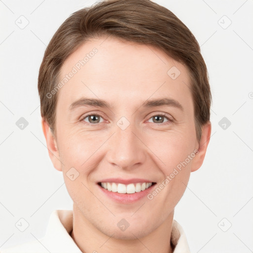 Joyful white young-adult male with short  brown hair and grey eyes