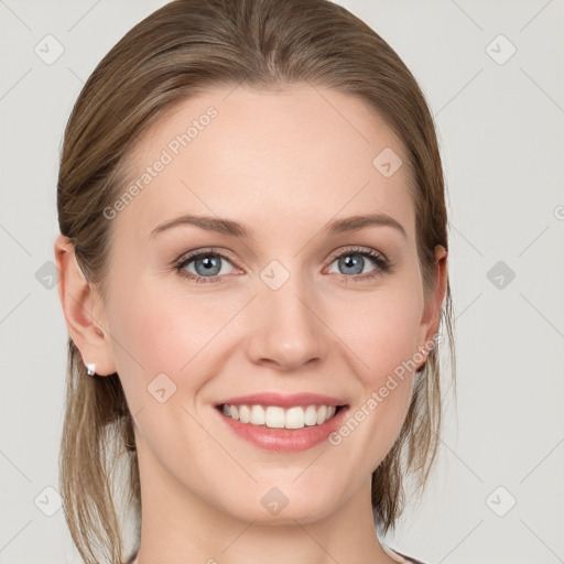 Joyful white young-adult female with medium  brown hair and blue eyes