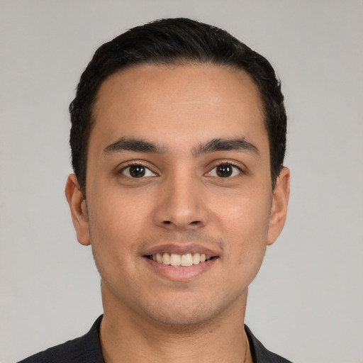 Joyful white young-adult male with short  black hair and brown eyes
