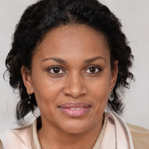 Joyful black young-adult female with medium  brown hair and brown eyes