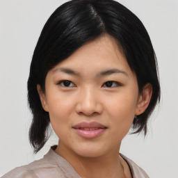 Joyful asian young-adult female with medium  black hair and brown eyes