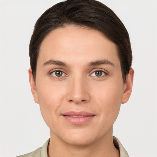 Joyful white young-adult female with short  brown hair and brown eyes