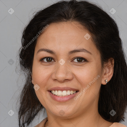 Joyful latino adult female with medium  brown hair and brown eyes