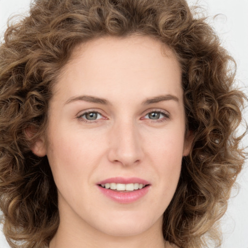 Joyful white young-adult female with long  brown hair and green eyes