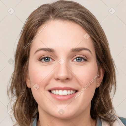 Joyful white young-adult female with medium  brown hair and blue eyes