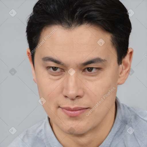 Joyful asian young-adult male with short  brown hair and brown eyes