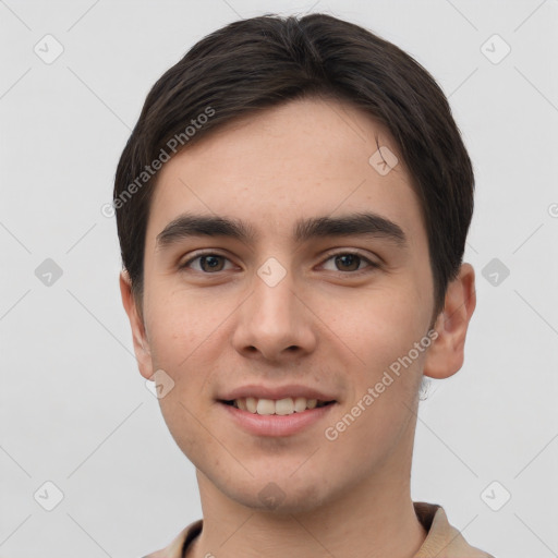 Joyful white young-adult male with short  brown hair and grey eyes