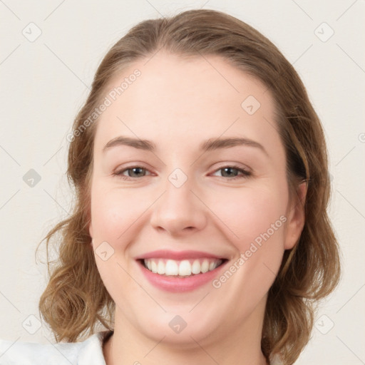 Joyful white young-adult female with medium  brown hair and blue eyes