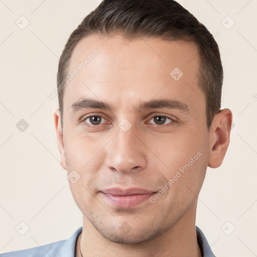 Joyful white young-adult male with short  brown hair and brown eyes