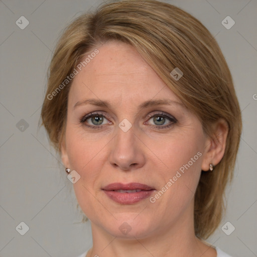 Joyful white adult female with medium  brown hair and blue eyes