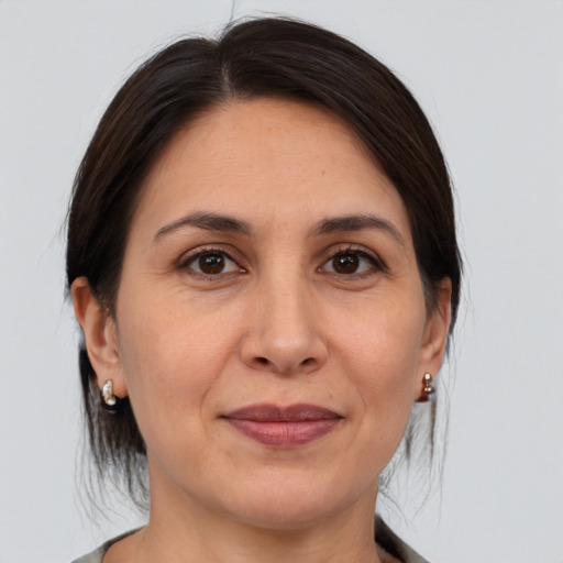 Joyful white adult female with medium  brown hair and brown eyes