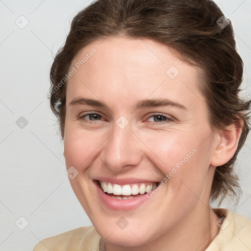 Joyful white young-adult female with medium  brown hair and blue eyes