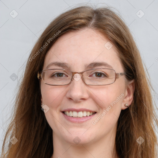 Joyful white adult female with long  brown hair and blue eyes