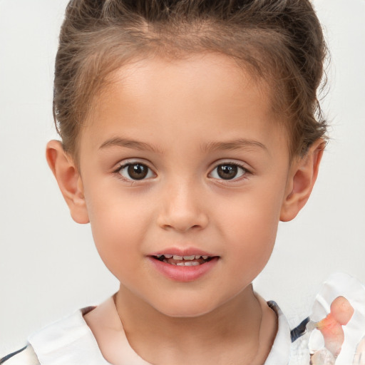 Joyful white child female with short  brown hair and brown eyes