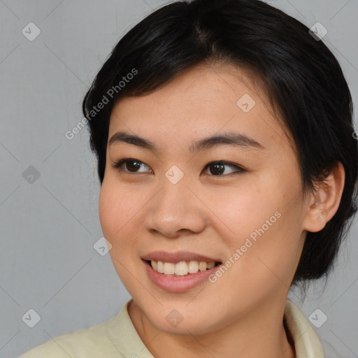 Joyful asian young-adult female with medium  brown hair and brown eyes