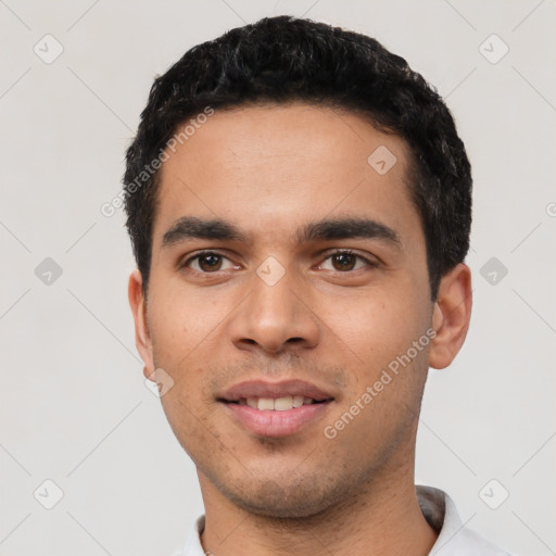 Joyful latino young-adult male with short  black hair and brown eyes