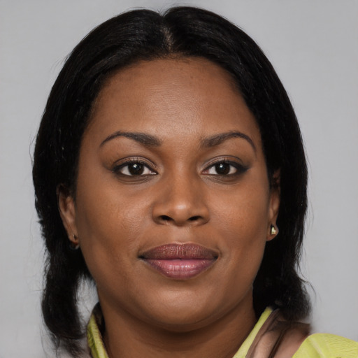 Joyful black young-adult female with medium  brown hair and brown eyes
