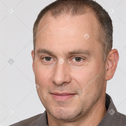 Joyful white adult male with short  brown hair and brown eyes