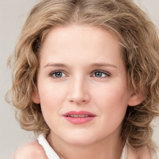 Joyful white young-adult female with medium  brown hair and blue eyes