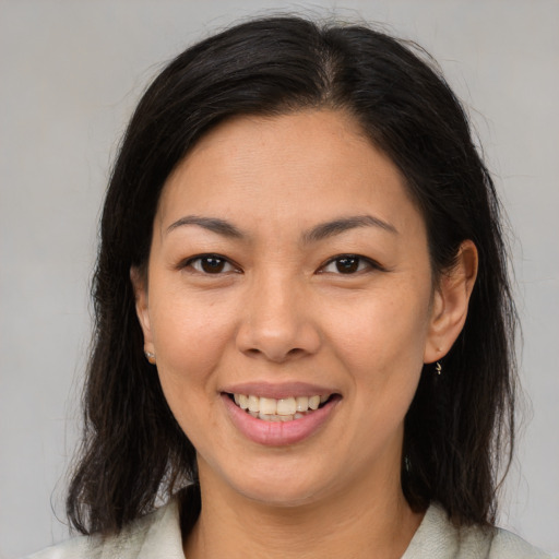 Joyful asian young-adult female with medium  brown hair and brown eyes