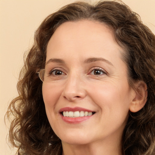 Joyful white adult female with long  brown hair and green eyes