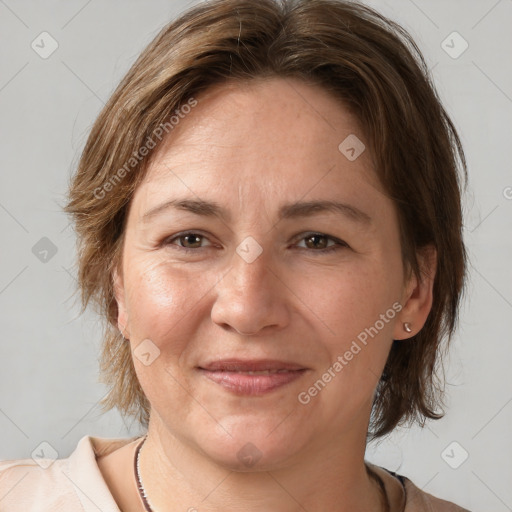 Joyful white adult female with medium  brown hair and brown eyes