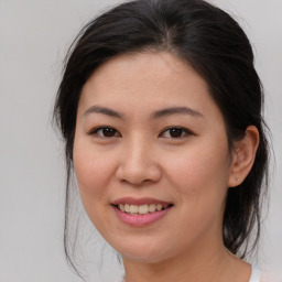 Joyful asian young-adult female with medium  brown hair and brown eyes