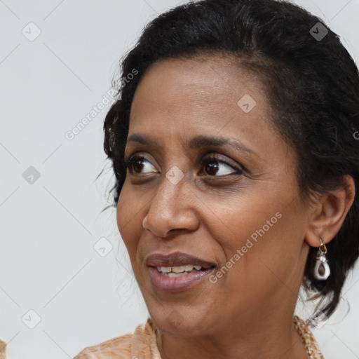 Joyful black adult female with medium  brown hair and brown eyes