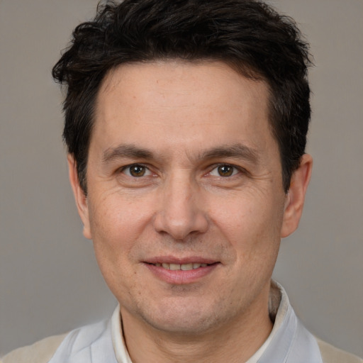 Joyful white adult male with short  brown hair and brown eyes