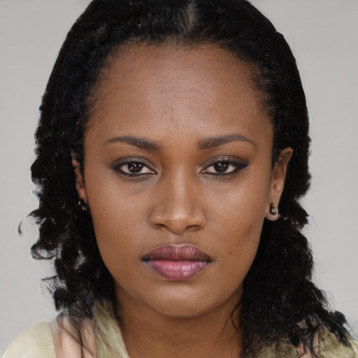 Neutral black young-adult female with long  brown hair and brown eyes